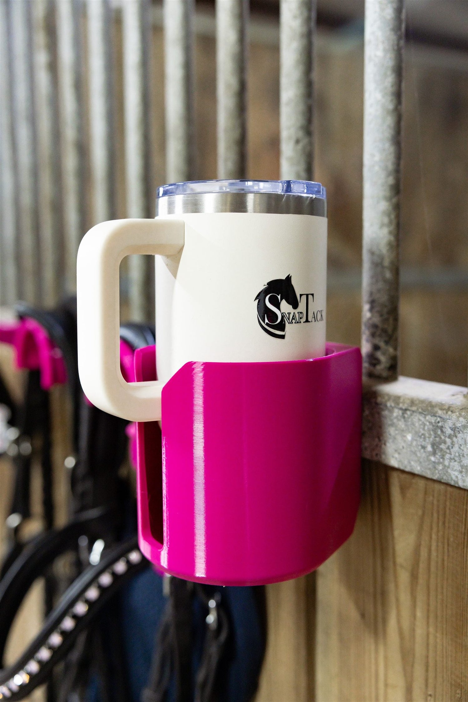 Insulated cup in a pink SnapTack magnetic cup holder at the stable