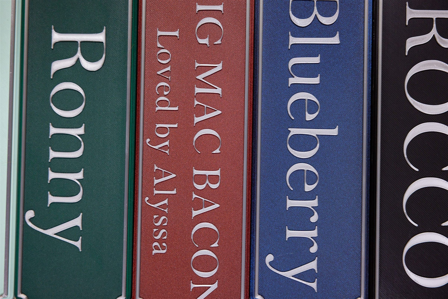 Personalised magnetic stable door name plates in a stack of colours