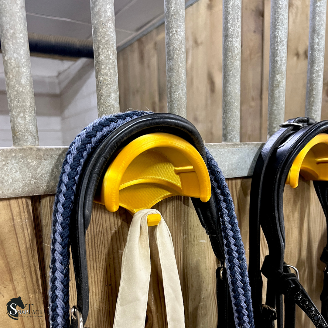 SnapTack magnetic bridle holder with hook for equestrian tack storage - gold in use