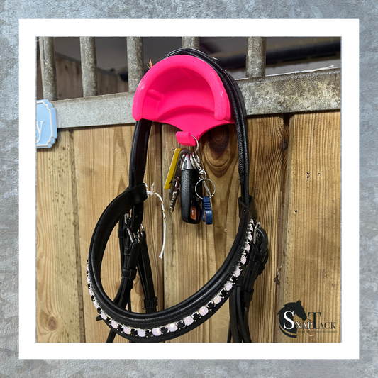 SnapTack magnetic bridle holder with hook for equestrian tack storage pink in use