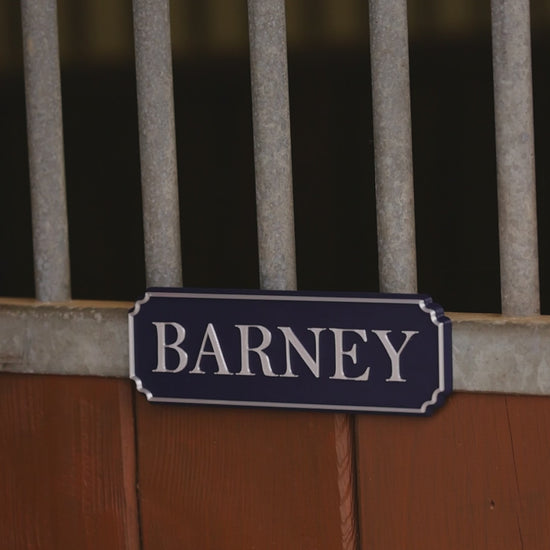 SnapTack magnetic name plate snapping onto a stable door