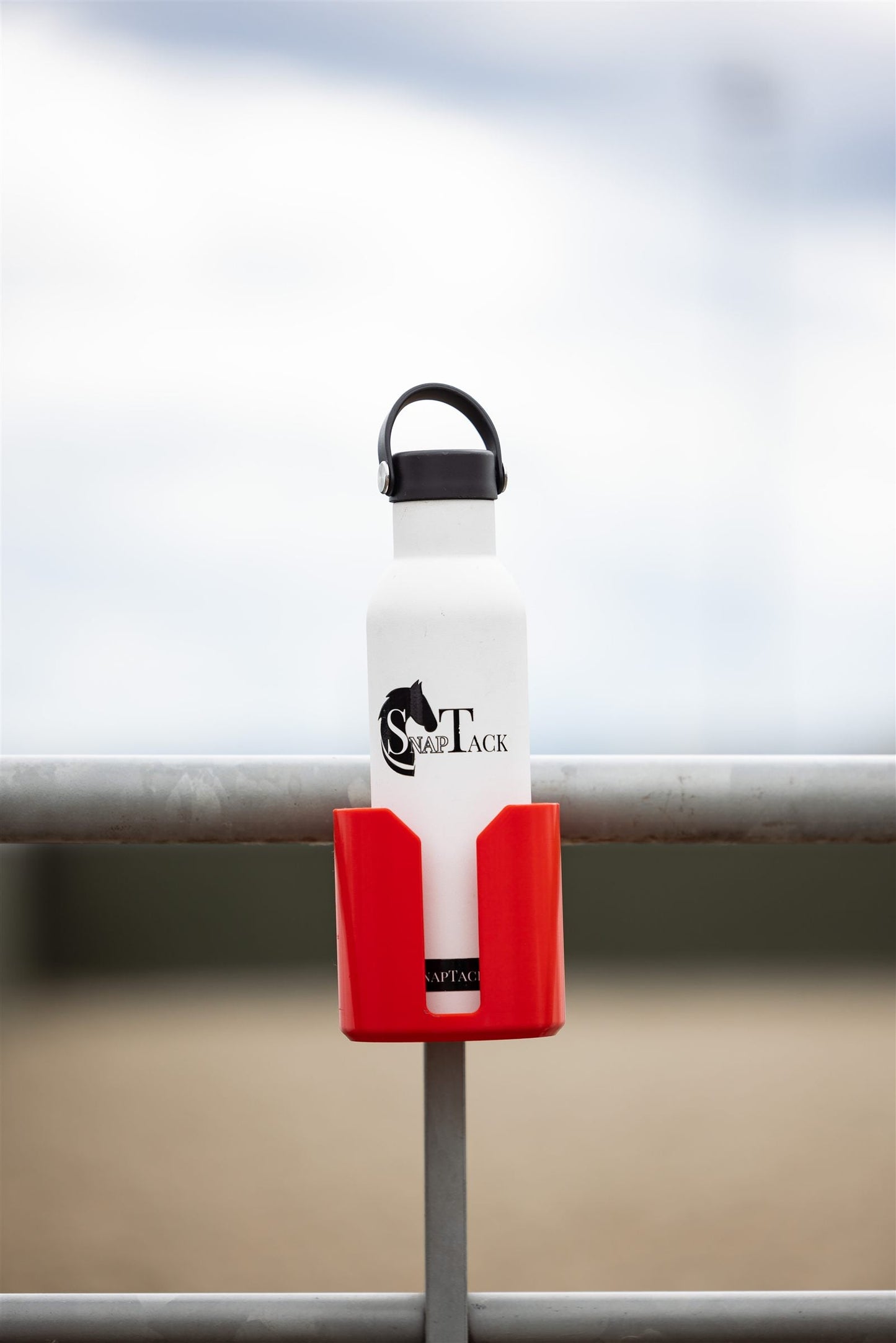 Water bottle in a red SnapTack magnetic cup holder at the arena