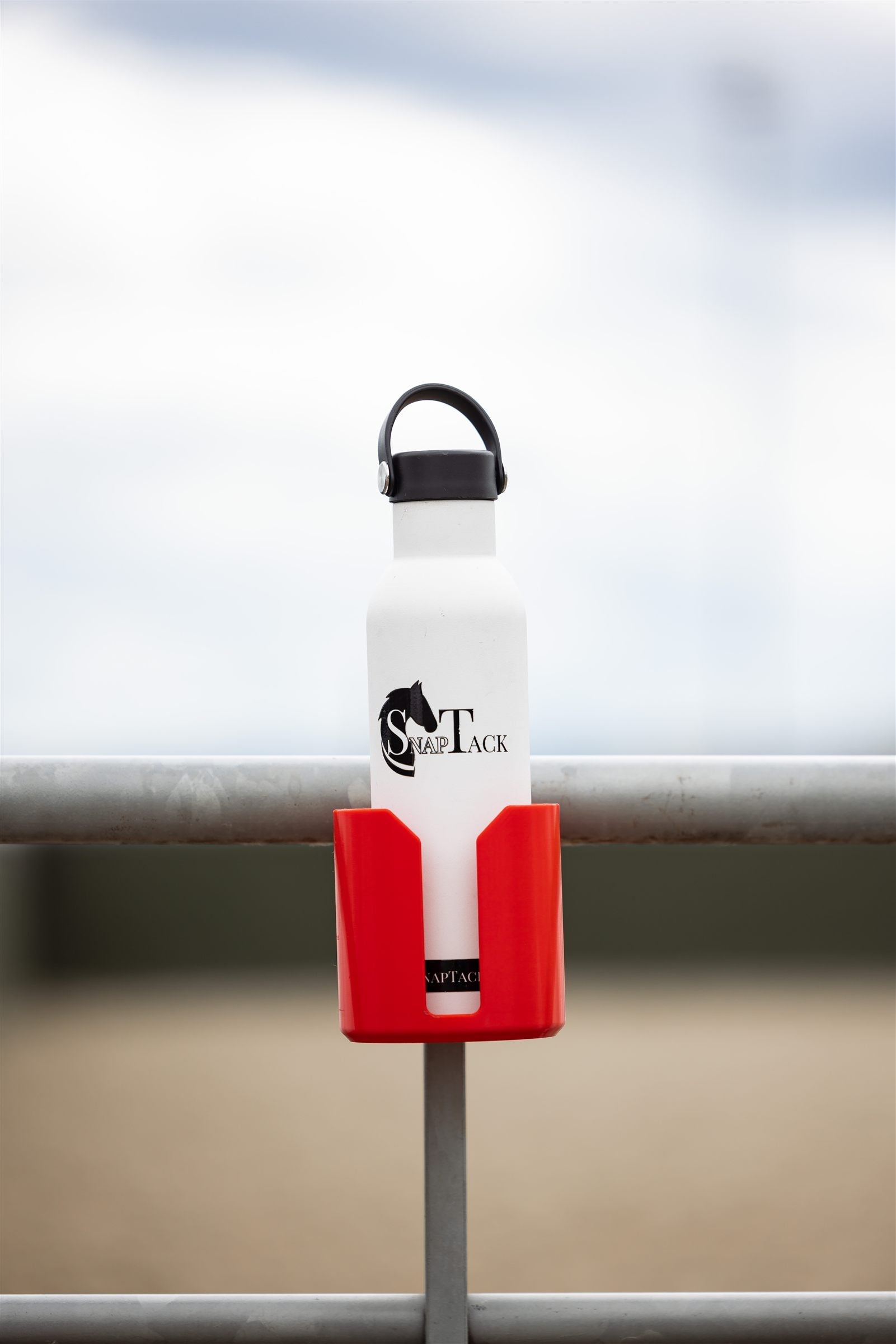 Water bottle in a red SnapTack magnetic cup holder at the arena