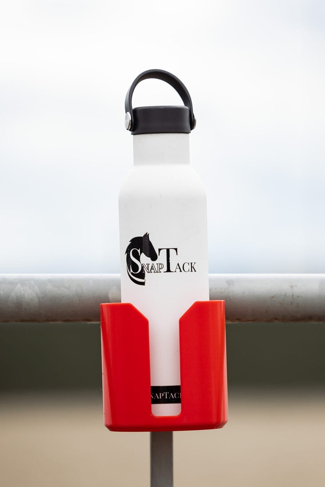Water bottle in a red SnapTack magnetic cup holder at the arena