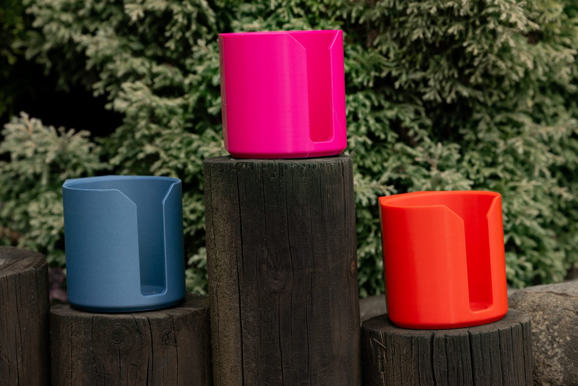 SnapTack magnetic cup holders in pink, blue and red