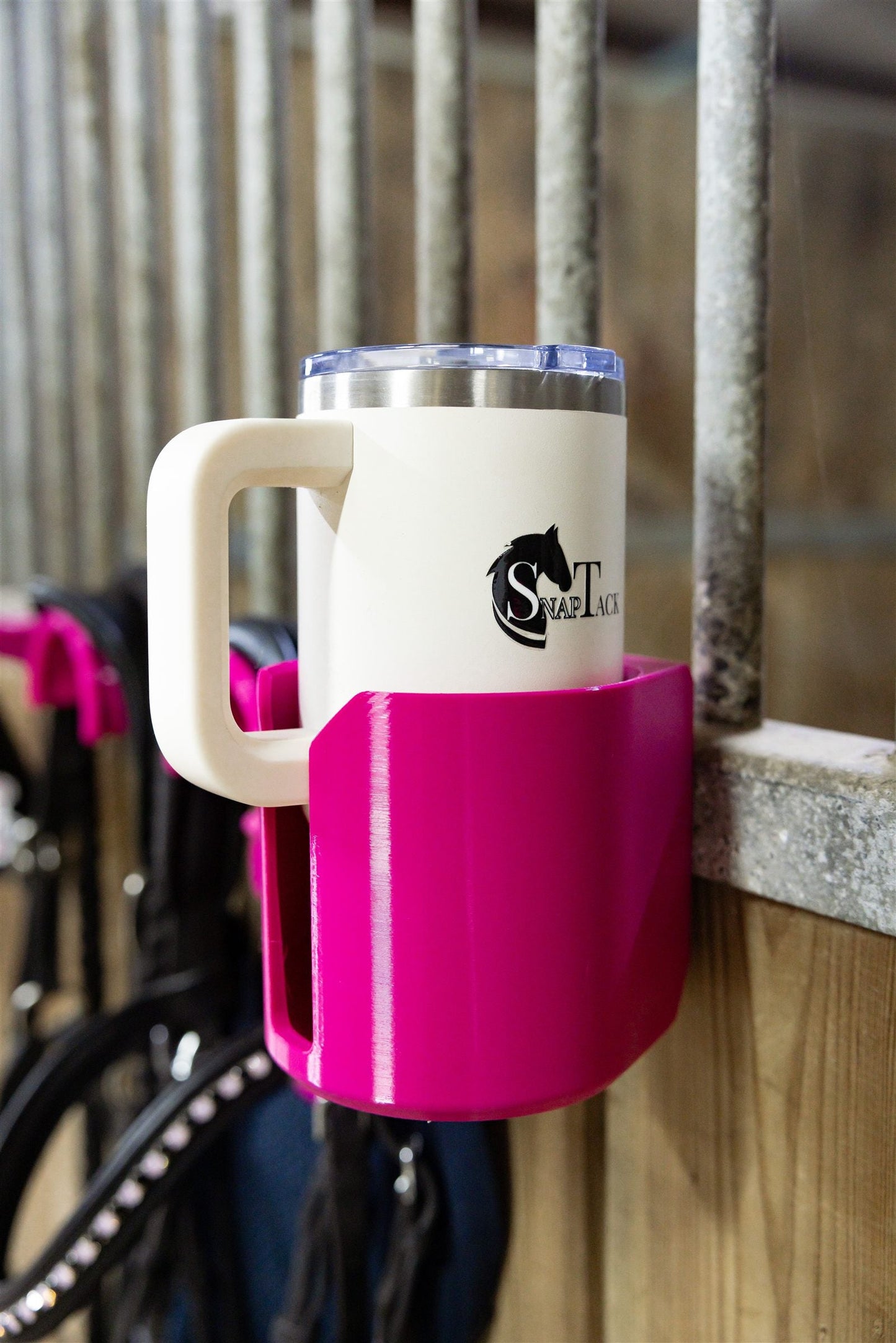 Insulated cup in a pink SnapTack magnetic cup holder at the stable