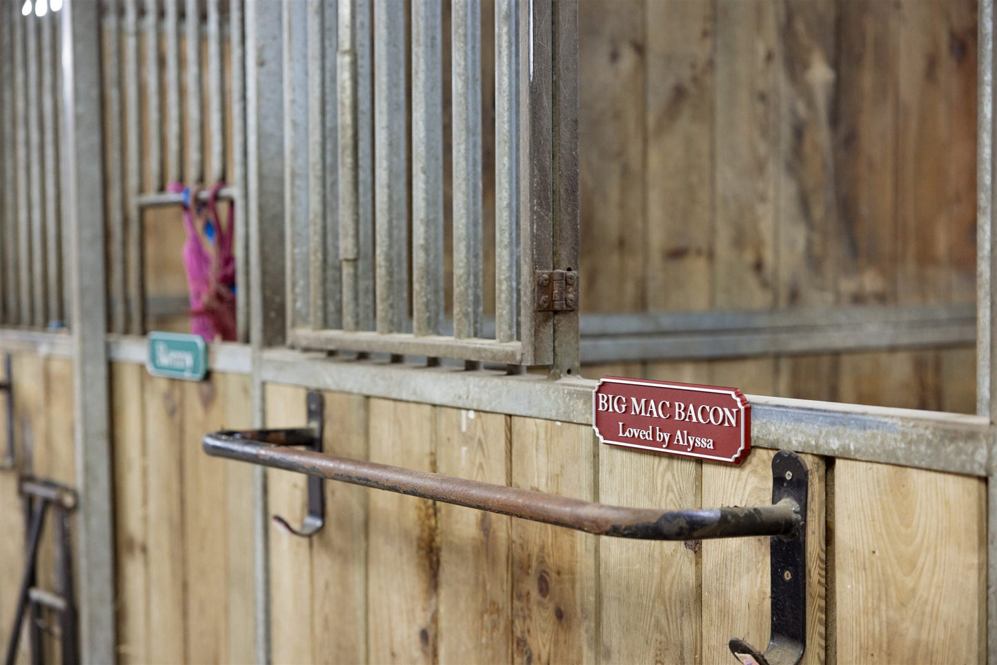 Red personalised magnetic door sign on a wooden stable door
