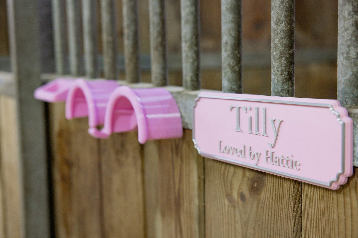 Pink personalised stable door sign reading Tilly with matching magnetic bridle hook