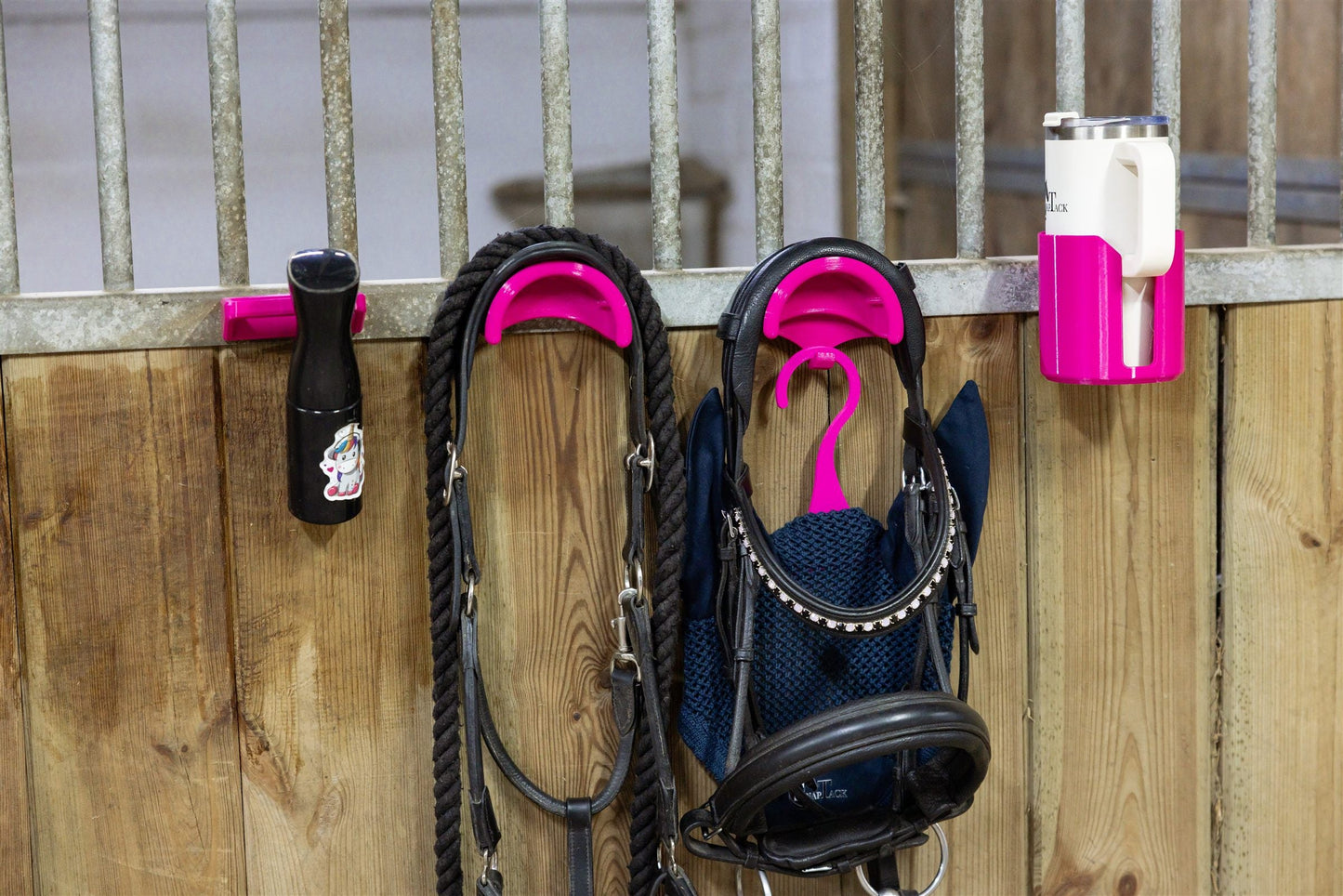 Pink magnetic bridle holder with hook holding a bridle and lead rope