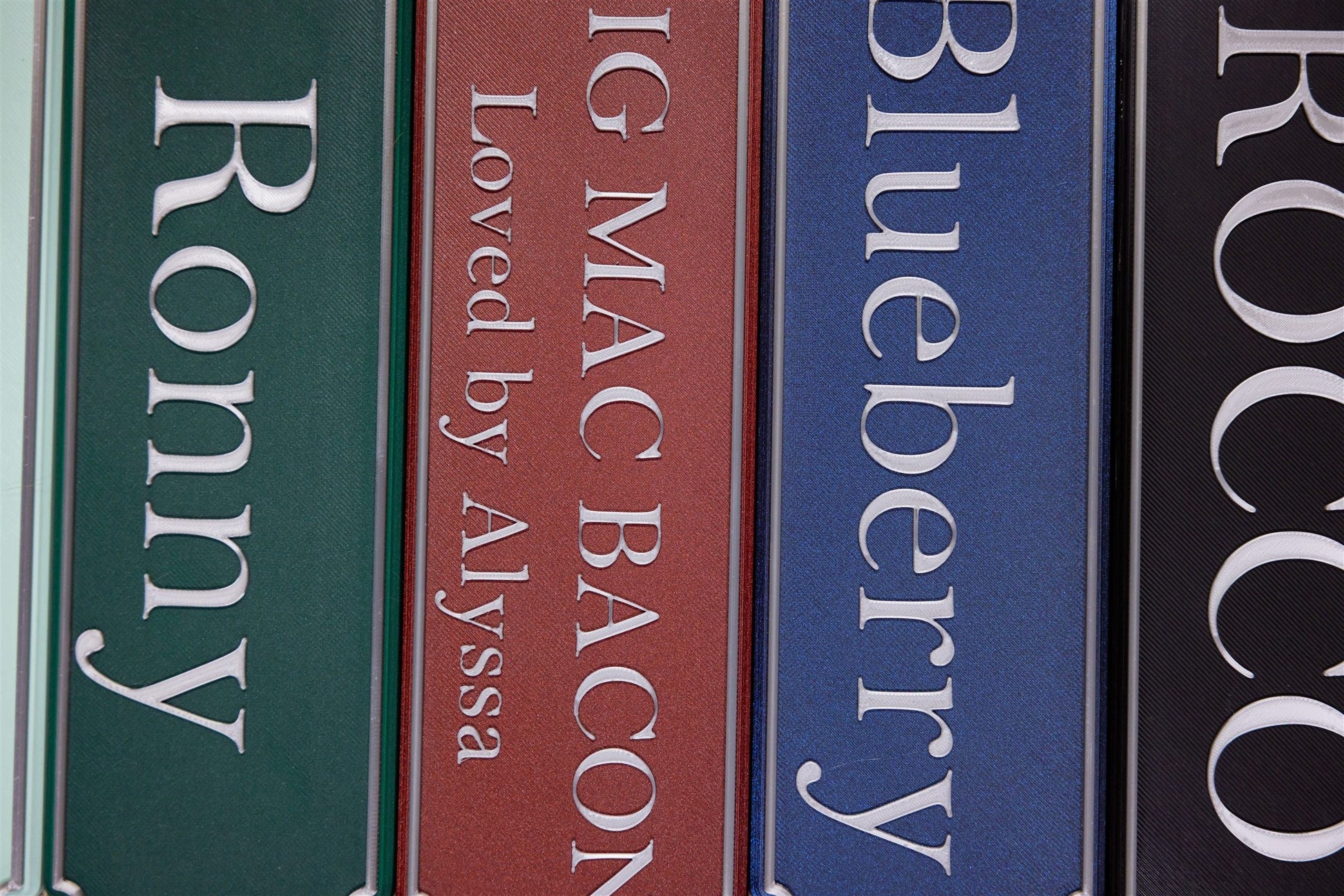 Personalised magnetic stable door name plates in a stack of colours
