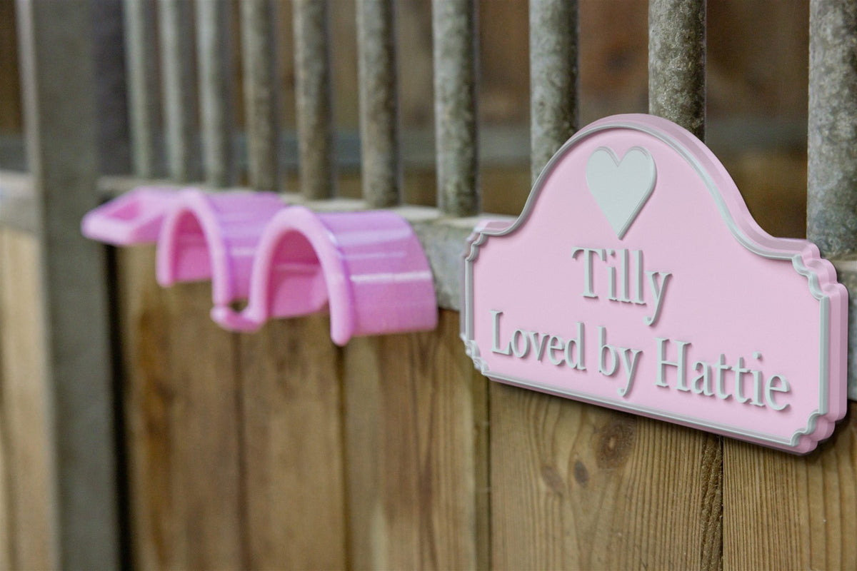 Render: pink SnapTack door sign with a heart, Tilly - Loved by Hattie, beside matching pink magnetic bridle holders with hook